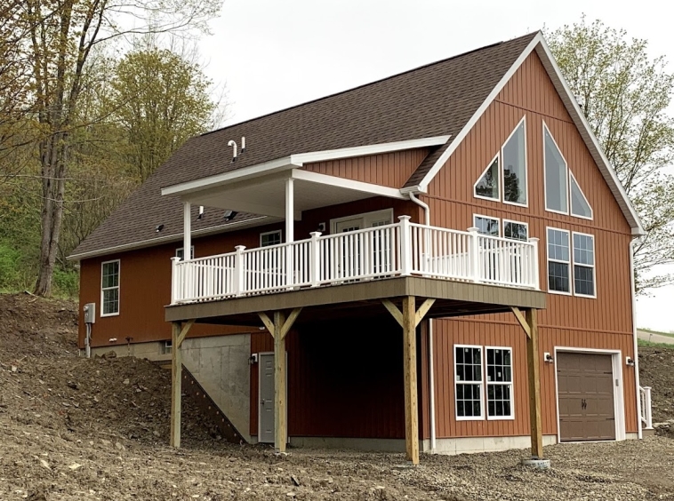 Completed modular homes chalet in Ellicottville New York which has a partially covered porch, basement garage, and was designed as a second vacation home.