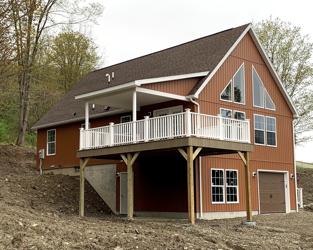 Completed modular homes chalet in Ellicottville New York which has a partially covered porch, basement garage, and was designed as a second vacation home.